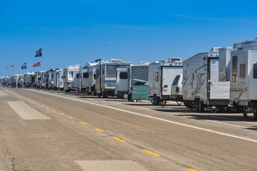Row of recreational vehicles parked on road