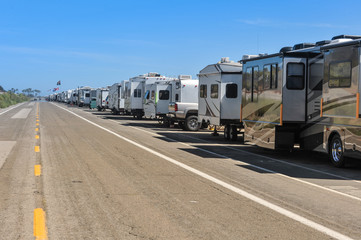 Row of recreational vehicles parked on road