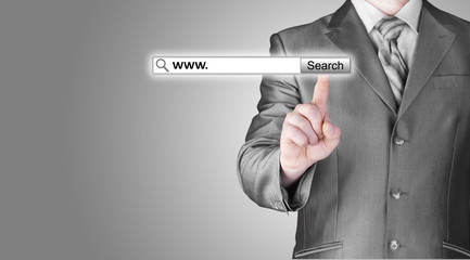 Businessman pushing virtual search bar