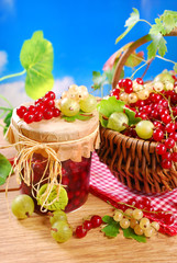 basket of fresh red,white currant ,gooseberry and jar of preserv