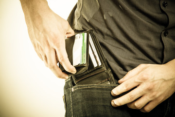 Closeup. Man taking wallet out on his pocket. Pay and theft.