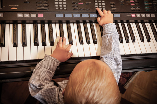 Boy Child Kid Playing On Digital Keyboard Piano Synthesizer