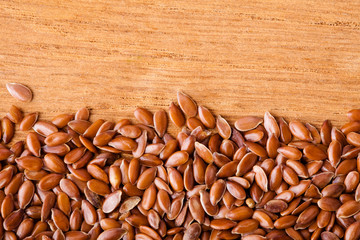 Healthy diet. Flax seeds linseed border on wooden background