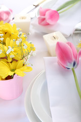 Fototapeta na wymiar Table setting with spring flowers close up
