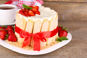 Tasty cake Charlotte with fresh strawberries on wooden table