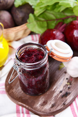 Grated beetroots in jar on table close-up