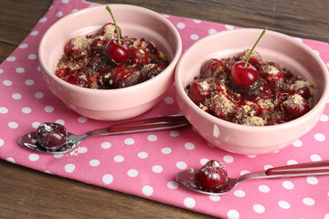 Tasty cherry dessert on table