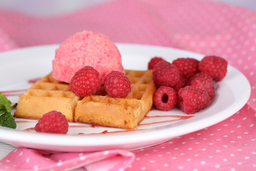Tasty belgian waffles with ice cream on wooden table