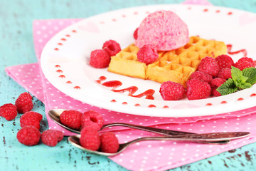 Tasty belgian waffles with ice cream on wooden table