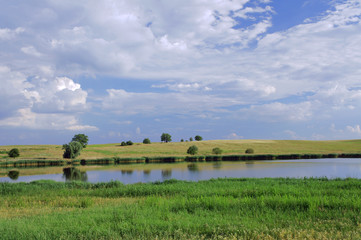 Rural landscape with a lake in Poland .