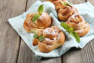 Tasty buns with berries on table close-up