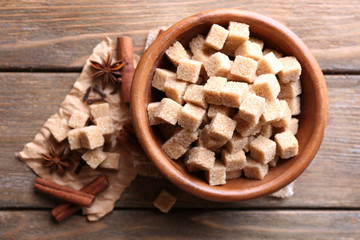 Brown sugar cubes in bowl, star anise and cinnamon sticks