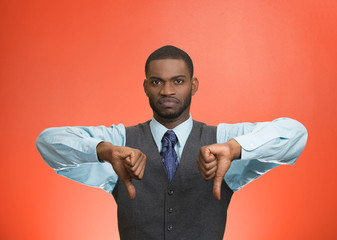 Displeased customer executive man giving thumbs down gesture