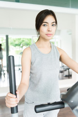 Naklejka na ściany i meble Woman workout at fitness