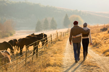 Fototapeta na wymiar young couple walking in farm road