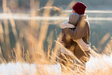 back view of young couple hugging in winter