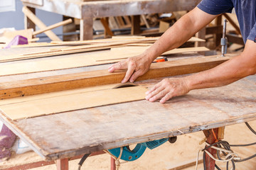 carpenter use saw cut wood formake new furniture