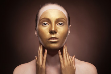 Woman with fashion art make up on brown background