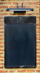 Black board on brick wall