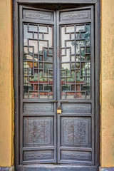 Fototapeta na wymiar Carved wooden door with rusty old lock