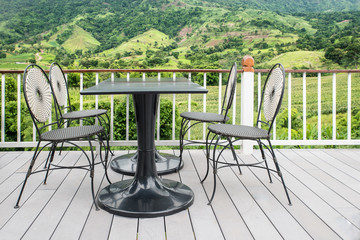 Table and chair on terrace with nature in background