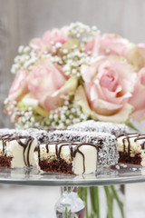 Chocolate and marzipan cakes on glass cake stand.