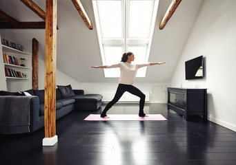 Healthy woman exercising in living room