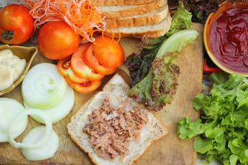 making tuna sandwich with fresh vegetables