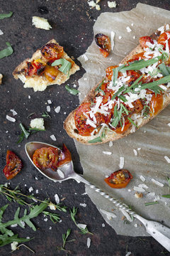 bruschetta with baked cherry tomatoes, parmesan and rocket