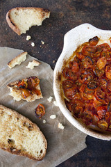 cherry tomatoes baked on vintage baking tin with toasted bread