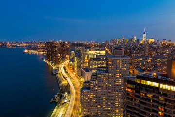 Fototapeta premium New York City skyline with urban skyscrapers at sunset.