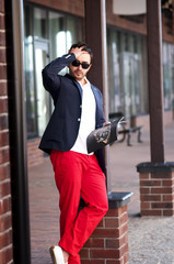 Stylish handsome man reading a magazine on walks.