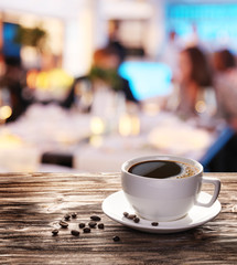 Cup of hot coffee on a old wooden table.