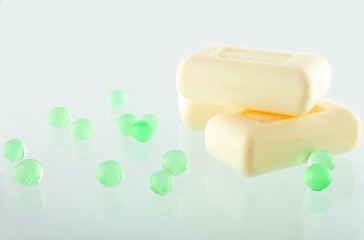 Three Soap Bars on the Greenish Background