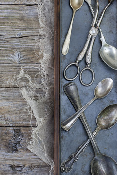 ancient vintage silver teaspoon and scissor on tray
