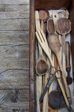 vintage old wooden cooking utensils group on wooden table