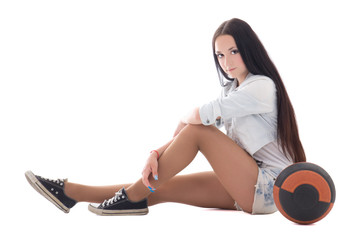Cute teenager in denim sitting with ball