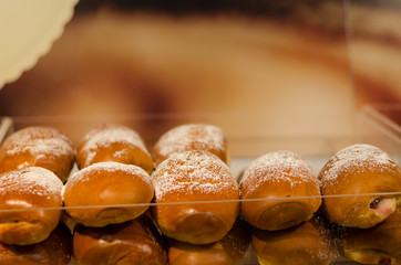 backed yeast bun row with powdered sugar