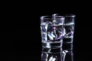 Two glasses of vodka with ice cubes