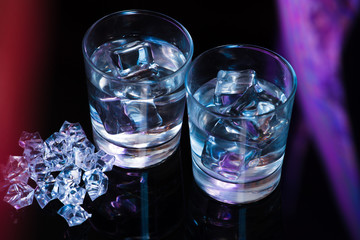 Two glasses of vodka with ice cubes