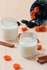 yogurt  with dried apricots and prunes in the wooden table