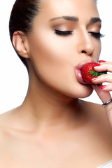 Beautiful Young Woman Eating Strawberry