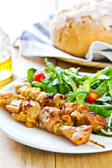 Grilled chicken skewer with salad