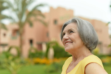Senior woman on a walk in tropic resort