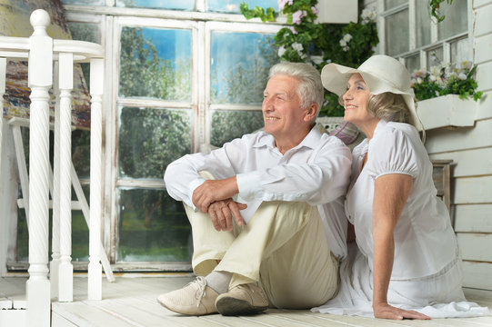 Elderly Couple On Wooden Porch