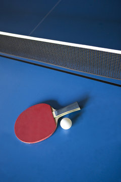 Racket and ball on a ping pong table