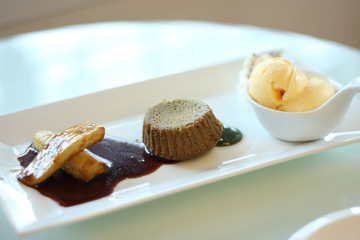 green tea lava cake served with ice cream and banana in syrup