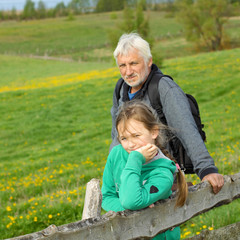 Naklejka na ściany i meble Grandfather with his granddaughter travel at attractive places. 