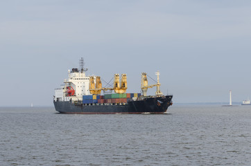 Cargo ship sailing in still water