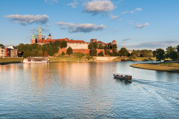 Naklejka premium The boat on Vistula River near Wawel Royal Castle in Krakow